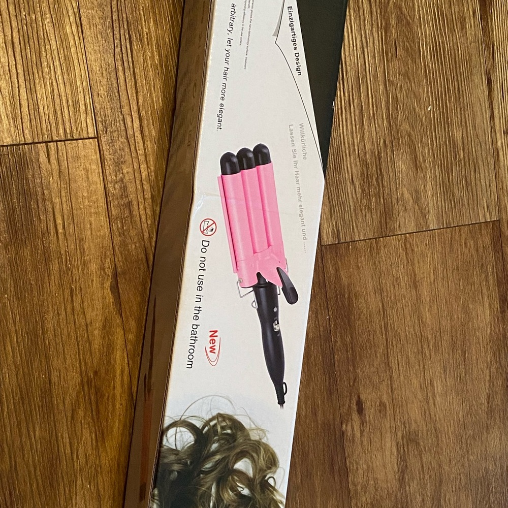 NEW. NEVER USED. Hair wave iron.